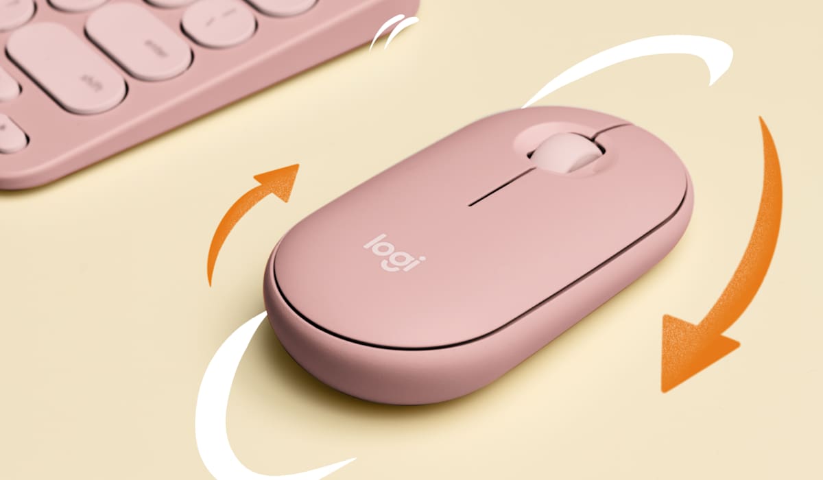 Rose Logitech Pebble Mouse 2 beside a keyboard, manufacturer photograph